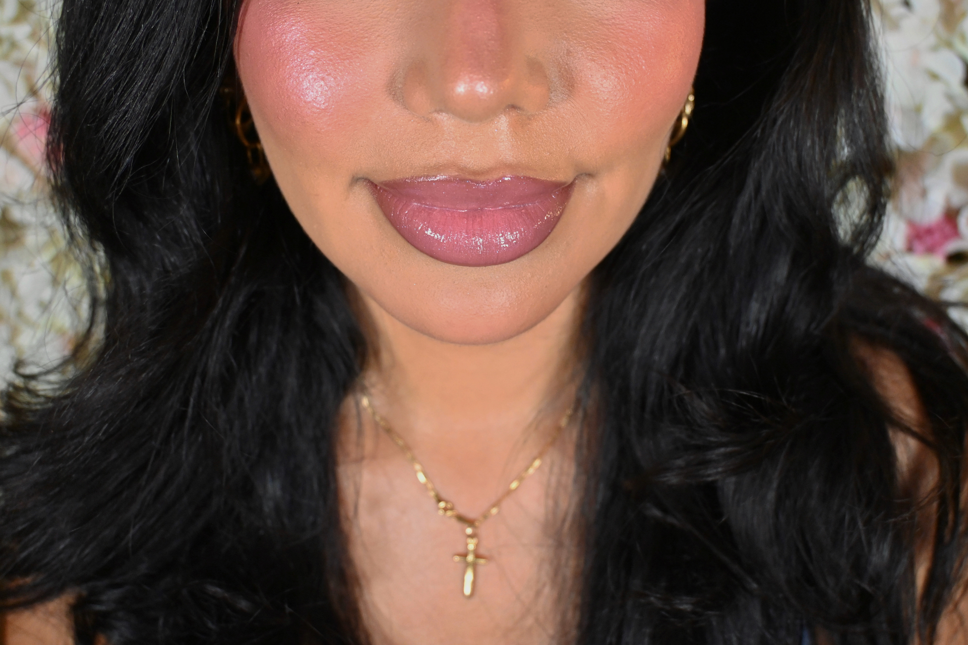 Close-up beauty look with luminous skin, rosy blush and glossy mauve lips