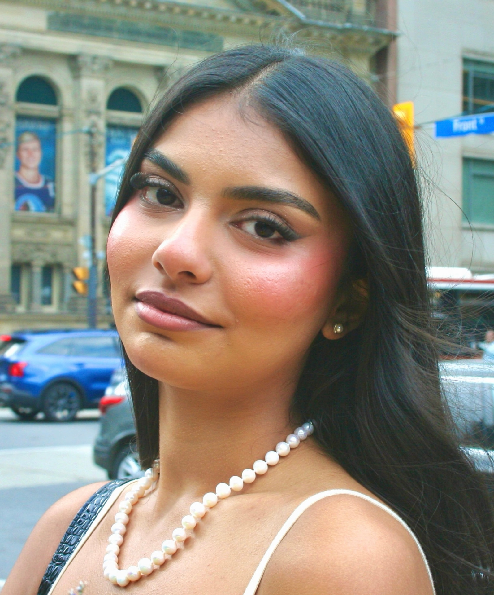 Fresh graduation makeup with soft pink cheeks and defined eyes