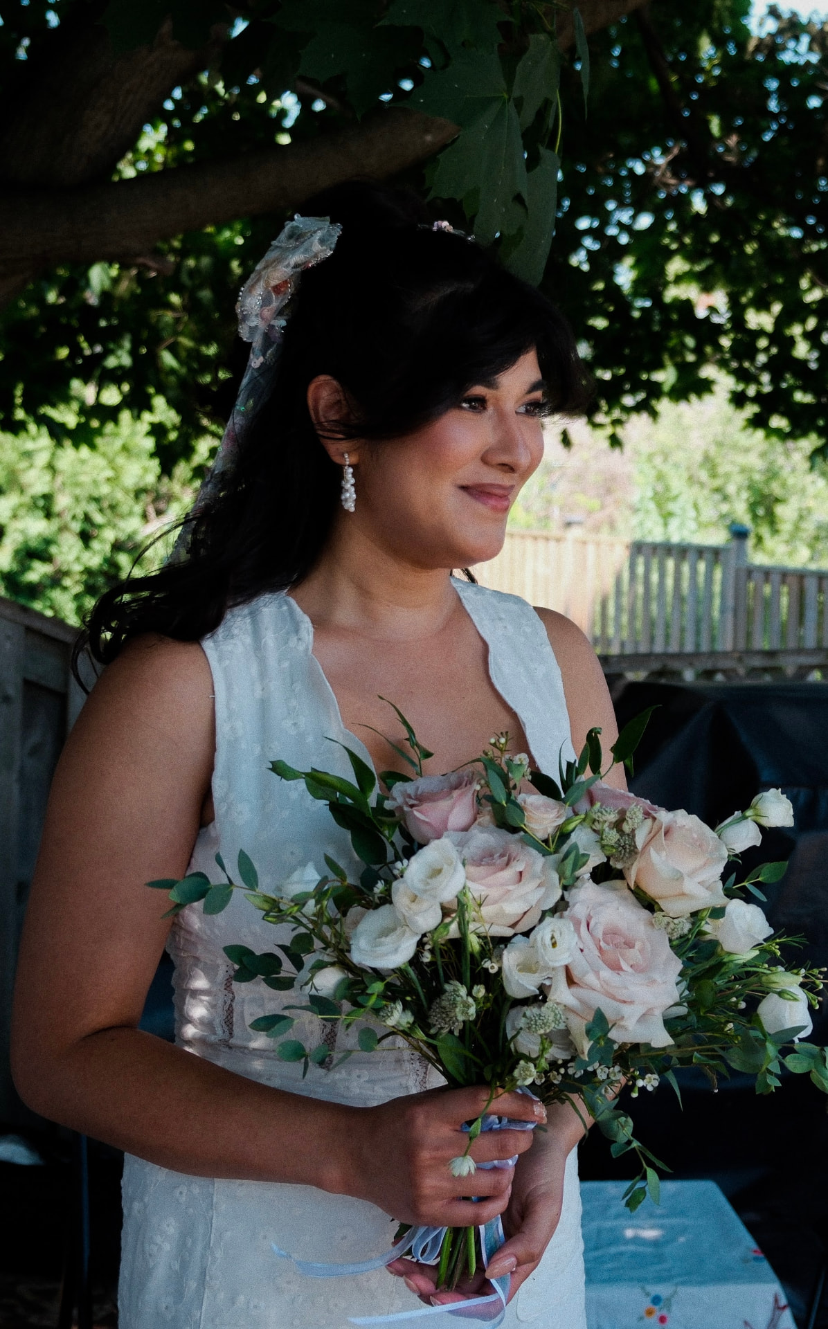 Bride holding a bouquet in soft wedding-day makeup