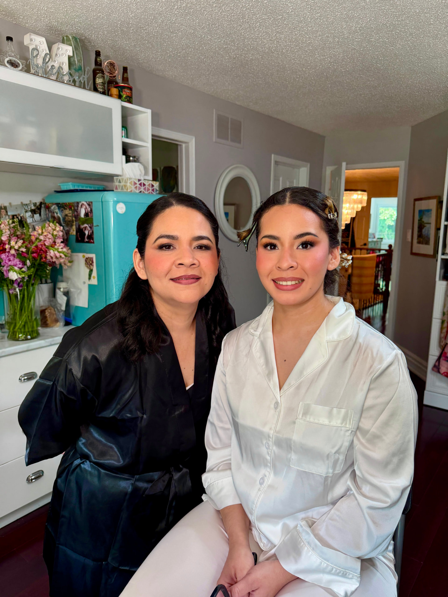 Two people with polished evening makeup in warm brown and rose-gold tones